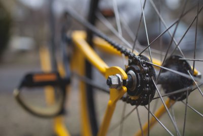 Bike chain on a yellow bike.