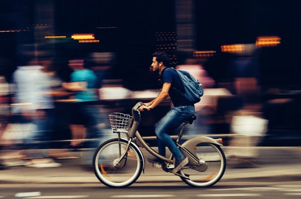 A person riding a bike on a street.