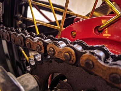 A close-up photo of a bike chain and wheel.